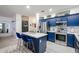 Kitchen island featuring blue cabinets, white counters, and seating for two at 14733 N 159Th Dr, Surprise, AZ 85379