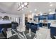 Open floor plan featuring a kitchen with blue cabinets and island that opens to the living room at 14733 N 159Th Dr, Surprise, AZ 85379