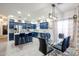 Eat in kitchen featuring blue cabinets, a kitchen island and dining table at 14733 N 159Th Dr, Surprise, AZ 85379
