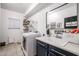 Clean and functional laundry room equipped with modern washer, dryer, utility sink, and ample storage cabinets at 14733 N 159Th Dr, Surprise, AZ 85379