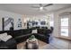 Comfortable living room featuring a large sectional sofa, ceiling fan and view to the kitchen at 14733 N 159Th Dr, Surprise, AZ 85379