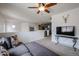 Cozy upstairs living room features neutral carpet, comfy sectional, and mounted television at 14733 N 159Th Dr, Surprise, AZ 85379