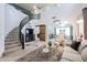 Spacious living room featuring a staircase, modern decor, and a view into other living spaces at 14733 N 159Th Dr, Surprise, AZ 85379