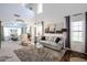 Bright living room with high ceilings, neutral carpet, and large windows allowing ample natural light at 14733 N 159Th Dr, Surprise, AZ 85379