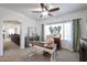Bright and airy home office with a stylish desk, ample lighting, and a view into another room at 14733 N 159Th Dr, Surprise, AZ 85379