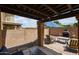 Inviting covered patio with brick pavers, outdoor seating, and a cozy fireplace, ideal for relaxation at 14733 N 159Th Dr, Surprise, AZ 85379