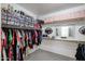 Spacious walk-in closet with organized storage solutions, including shelving, hanging rods, and storage bins at 14733 N 159Th Dr, Surprise, AZ 85379