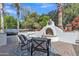 Inviting backyard features a white stucco fireplace with seating, perfect for outdoor relaxation at 1556 E Vesper Trl, Queen Creek, AZ 85140