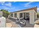Back patio has an outdoor seating area and an additional dining area under the covered porch at 1556 E Vesper Trl, Queen Creek, AZ 85140