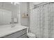Bathroom with a neutral vanity, chrome faucet, and a tiled shower with a modern curtain at 1556 E Vesper Trl, Queen Creek, AZ 85140