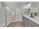 Bathroom showcasing a double vanity with a large mirror and a tiled glass shower at 1556 E Vesper Trl, Queen Creek, AZ 85140