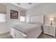 Bright bedroom featuring neutral walls, blinds, and a full bed with a bedside table at 1556 E Vesper Trl, Queen Creek, AZ 85140