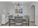 An elegant dining room features modern lighting and gray wood dining table at 1556 E Vesper Trl, Queen Creek, AZ 85140