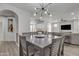 Open-concept dining room boasts an archway and view of kitchen and living room at 1556 E Vesper Trl, Queen Creek, AZ 85140
