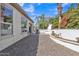 The exterior features a backyard with an outdoor seating area and luscious green trees at 1556 E Vesper Trl, Queen Creek, AZ 85140