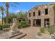 Unique stone home featuring an open-air garage and lush landscaping at 1556 E Vesper Trl, Queen Creek, AZ 85140