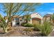 Charming single-story home with desert landscaping, a private gate, and an attached two-car garage at 1556 E Vesper Trl, Queen Creek, AZ 85140