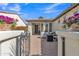 Inviting front porch with comfortable seating area, gated entrance, and stylish brick pavers at 1556 E Vesper Trl, Queen Creek, AZ 85140