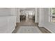 Hallway view to dining, kitchen, and sitting room shows the open floorplan at 1556 E Vesper Trl, Queen Creek, AZ 85140