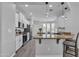 Bright, open kitchen with white cabinets, granite countertops, stainless steel appliances, and eat-in island at 1556 E Vesper Trl, Queen Creek, AZ 85140