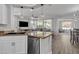 Open concept kitchen with stainless appliances, granite counters, island, and view to the living area at 1556 E Vesper Trl, Queen Creek, AZ 85140