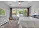 Comfortable main bedroom offers large windows and a ceiling fan at 1556 E Vesper Trl, Queen Creek, AZ 85140