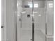 Shower with glass doors featuring a rainfall shower head and bench seating at 1556 E Vesper Trl, Queen Creek, AZ 85140