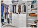 A walk-in closet with custom built-in shelving and drawers for organized storage at 1556 E Vesper Trl, Queen Creek, AZ 85140