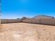 This property features a flat dirt backyard, and concrete walls for privacy at 16073 W Remuda Dr, Surprise, AZ 85387