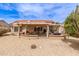 Beautiful backyard with covered patio, comfortable seating, and desert landscaping for easy maintenance and relaxation at 16331 W Tierra Way, Surprise, AZ 85374