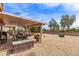 Inviting backyard with covered patio, outdoor dining, and low-maintenance desert landscaping, perfect for outdoor enjoyment at 16331 W Tierra Way, Surprise, AZ 85374