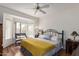 Bright bedroom with a large window, complemented by a decorative bench and a plush yellow throw blanket at 16331 W Tierra Way, Surprise, AZ 85374