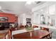 Open-concept dining area with a large wooden table, seating for six, and seamless access to the living area at 16331 W Tierra Way, Surprise, AZ 85374