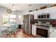 Charming kitchen featuring stainless steel appliances, white cabinets, and an adjacent dining nook bathed in natural light at 16331 W Tierra Way, Surprise, AZ 85374