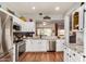 Modern kitchen showcases granite countertops, stainless steel appliances, sleek white cabinetry, and an open layout at 16331 W Tierra Way, Surprise, AZ 85374