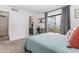 Bright bedroom with a sliding door leading to a balcony and an adjacent bathroom at 16336 E Palisades Blvd # 7, Fountain Hills, AZ 85268