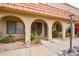 Charming front entrance with covered arched walkways, desert landscaping, and secure entry doors at 16336 E Palisades Blvd # 7, Fountain Hills, AZ 85268