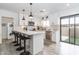 Modern kitchen features stainless steel appliances, white cabinets, and bar stool seating at 16336 E Palisades Blvd # 7, Fountain Hills, AZ 85268