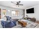 Well-lit living area with large window, ceiling fan, and a stylish entertainment center at 16336 E Palisades Blvd # 7, Fountain Hills, AZ 85268