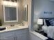 Well-lit bathroom featuring a quartz countertop, modern fixtures, and stylish decor at 16513 N 68Th Dr, Peoria, AZ 85382