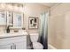 Clean bathroom with a vanity, storage, tub/shower combo, and a calming ambiance at 16513 N 68Th Dr, Peoria, AZ 85382