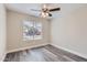Cozy bedroom with natural light, a ceiling fan, and contemporary flooring at 16513 N 68Th Dr, Peoria, AZ 85382