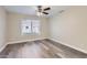 Comfortable bedroom with a ceiling fan, large window, and modern flooring at 16513 N 68Th Dr, Peoria, AZ 85382