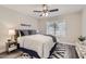 Inviting bedroom featuring a comfortable bed, wood-look flooring, and natural light at 16513 N 68Th Dr, Peoria, AZ 85382