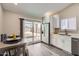 Bright eat-in kitchen features white cabinets, stainless appliances, and sliding door access to the backyard at 16513 N 68Th Dr, Peoria, AZ 85382