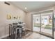 Cozy kitchen area with stainless steel table, white cabinets, and backyard access at 16513 N 68Th Dr, Peoria, AZ 85382