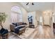 Bright living room featuring a vaulted ceiling, stylish furniture, and modern decor at 16513 N 68Th Dr, Peoria, AZ 85382