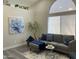 Cozy living room with a large window, gray sofa, and stylish decor at 16513 N 68Th Dr, Peoria, AZ 85382