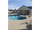 Community pool featuring lounge chairs, covered seating area, and desert landscaping at 16513 N 68Th Dr, Peoria, AZ 85382