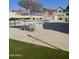 Community pool featuring a table with chairs under an umbrella and lounge chairs at 16513 N 68Th Dr, Peoria, AZ 85382